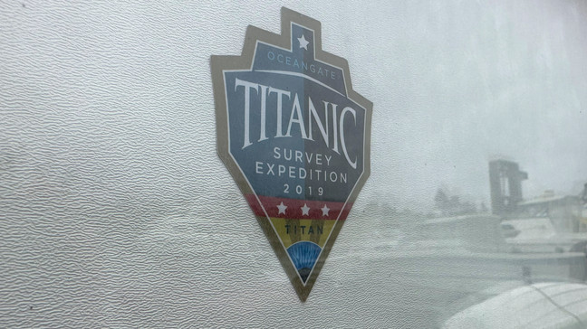 FILE - The logo for an OceanGate Expeditions 2019 Titanic expedition is seen on a marine industrial warehouse office door in Everett, Wash., Tuesday, June 20, 2023. Rescuers are racing against time to find the missing submersible carrying five people, who were reported overdue Sunday night. (AP Photo/Ed Komenda, File)