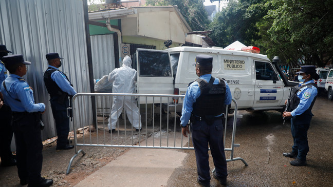 Forensic experts unload a body removed from a women's prison, at the medical morgue in Tegucigalpa, Honduras, Wednesday, June 21, 2023. A riot on Tuesday at the prison northwest of the Honduran capital left at least 46 female inmates dead, many of them burned, shot or stabbed to death, a Honduran police official said. (AP Photo/Elmer Martinez)